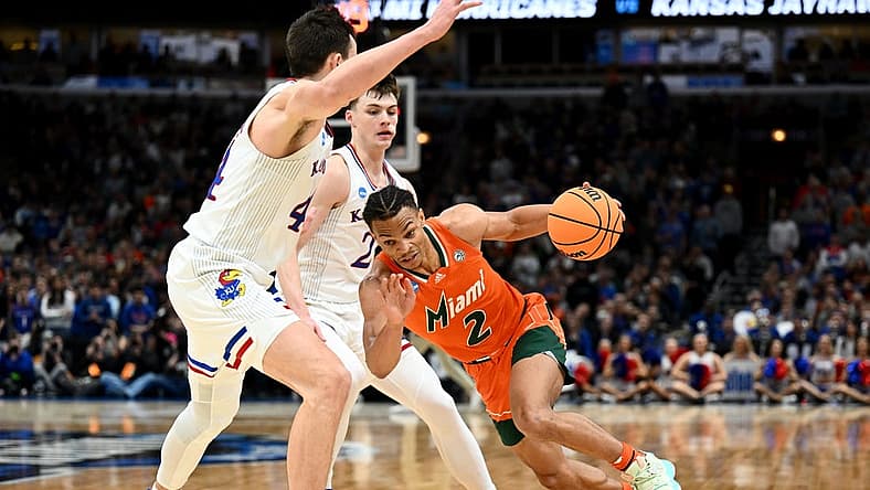 Mar 27, 2022; Chicago, IL, USA; Miami Hurricanes guard Isaiah Wong (2) drives against Kansas Jayhawks forward Mitch Lightfoot (44) during the second half in the finals of the Midwest regional of the men's college basketball NCAA Tournament at United Center. Mandatory Credit: Jamie Sabau-USA TODAY Sports
