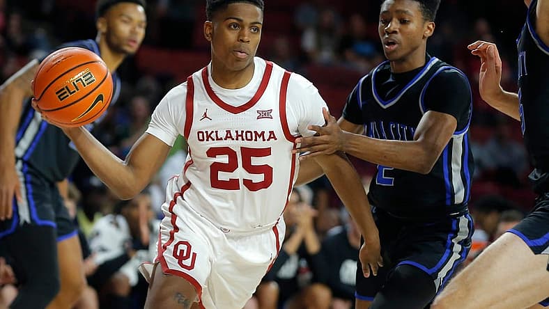 Oklahoma's Grant Sherfield (25) passes the ball as OCU's Avery Jackson defends during a college basketball exhibition game between the University of Oklahoma Sooners (OU) and the Oklahoma City University Starts (OCU) at Loyd Noble Center in Norman, Okla., Tuesday, Oct. 25, 2022.

Ou Men S Basketball