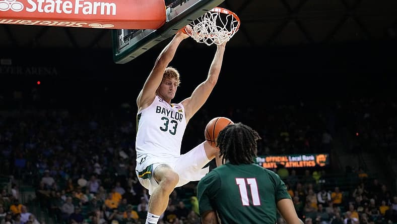 Nov 7, 2022; Waco, Texas, USA; Baylor Bears forward Caleb Lohner (33) dunks the ball against Mississippi Valley State Delta Devils guard Terry Collins (11) during the first half at Ferrell Center. Mandatory Credit: Chris Jones-USA TODAY Sports