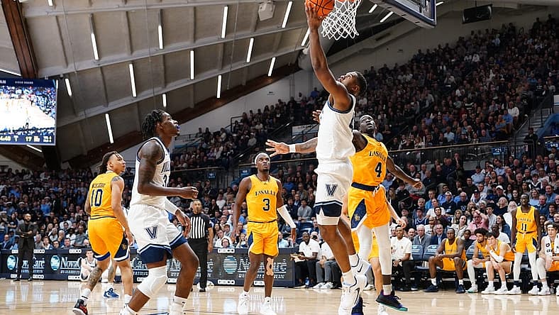 Nov 7, 2022; Villanova, Pennsylvania, USA; Villanova Wildcats forward Eric Dixon (43) shoots a reverse layup against La Salle Explorers forward Hassan Drame (4) during the first half at William B. Finneran Pavilion. Mandatory Credit: Gregory Fisher-USA TODAY Sports