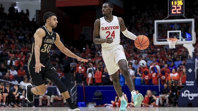Nov 7, 2022; Dayton, Ohio, USA; Dayton Flyers guard Kobe Elvis (24) dribbles the ball against Lindenwood Lions guard Chris Childs (30) in the second half at University of Dayton Arena. Mandatory Credit: Aaron Doster-USA TODAY Sports