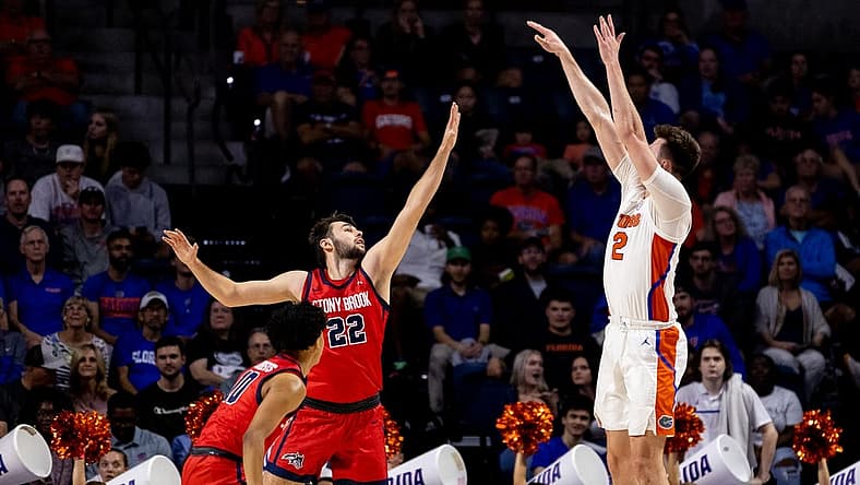 Nov 7, 2022; Gainesville, Florida, USA; Florida Gators forward Colin Castleton (12) shoots over Stony Brook Seawolves forward Kenan Sarvan (22) during the first half at Exactech Arena at the Stephen C. O'Connell Center. Mandatory Credit: Matt Pendleton-USA TODAY Sports