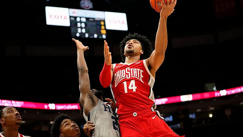 Nov 7, 2022; Columbus, Ohio, USA; Ohio State Buckeyes guard Justice Sueing (14) shoots over Robert Morris Colonials guard Chris Ford (23) during the first half of the NCAA men's basketball game at Value City Arena. Mandatory Credit: Adam Cairns-The Columbus Dispatch
Basketball Robert Morris At Ohio State Men S Basketball