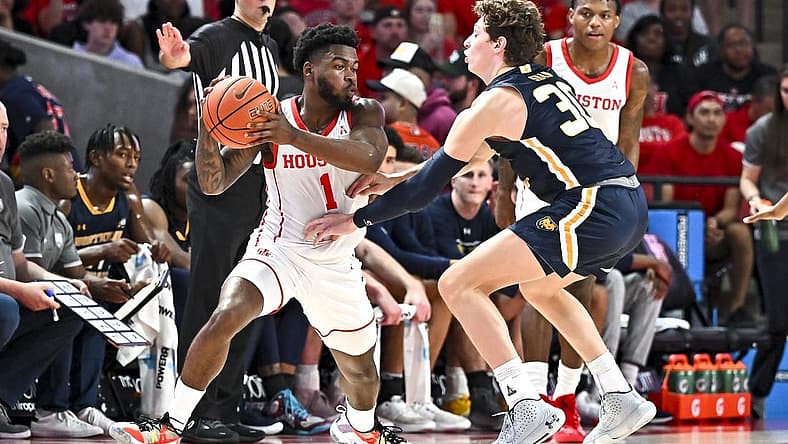 Nov 7, 2022; Houston, Texas, USA; Houston Cougars guard Jamal Shead (1) looks to pass the ball as Northern Colorado Bears guard Caleb Shaw (30) defends during the first half at Fertitta Center. Mandatory Credit: Maria Lysaker-USA TODAY Sports