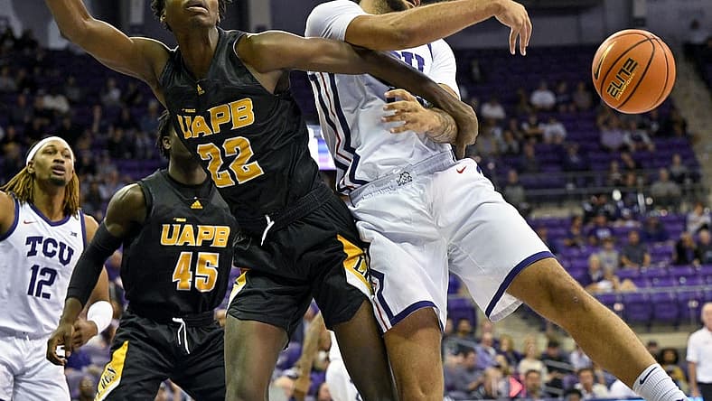Nov 7, 2022; Fort Worth, Texas, USA; TCU Horned Frogs forward JaKobe Coles (21) knocks the ball away from Arkansas-Pine Bluff Golden Lions forward Robert Lewis (22) during the first half at Ed and Rae Schollmaier Arena. Mandatory Credit: Jerome Miron-USA TODAY Sports