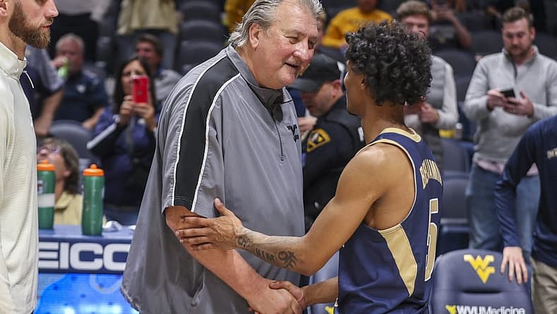 Nov 7, 2022; Morgantown, West Virginia, USA; West Virginia Mountaineers head coach Bob Huggins talks with Mount St. Mary's Mountaineers guard Jalen Benjamin (5) after the game at WVU Coliseum. Mandatory Credit: Ben Queen-USA TODAY Sports