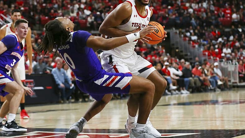 Nov 7, 2022; Lubbock, Texas, USA; Texas Tech Red Raiders forward Kevin Obanor (0) collides with Northwestern State Demons guard Greedy Williams (10) in the first half at United Supermarkets Arena. Mandatory Credit: Michael C. Johnson-USA TODAY Sports