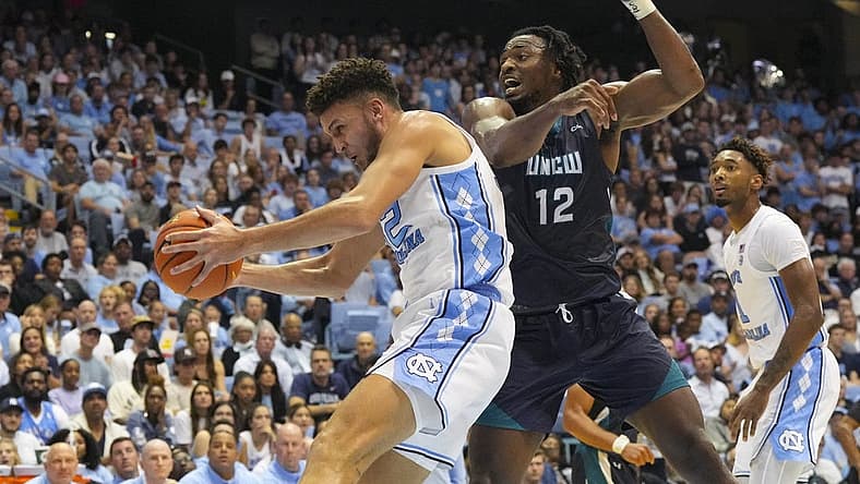 Nov 7, 2022; Chapel Hill, North Carolina, USA;  North Carolina Tar Heels forward Pete Nance (32) gets the rebound against North Carolina-Wilmington Seahawks center Victor Enoh (12) during the first half at Dean E. Smith Center. Mandatory Credit: James Guillory-USA TODAY Sports