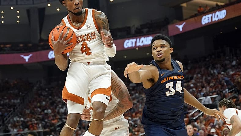 Nov 7, 2022; Austin, Texas, USA; Texas Longhorns forward guard Tyrese Hunter (4) grabs a rebound away from Texas-El Paso Miners forward Kevin Kalu (34) during the first half at Moody Center. Mandatory Credit: Scott Wachter-USA TODAY Sports