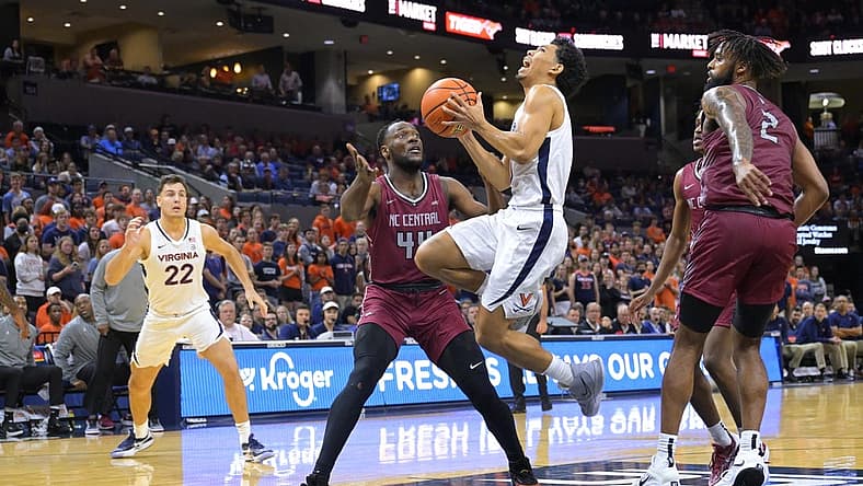 Nov 7, 2022; Charlottesville, Virginia, USA; Virginia Cavaliers guard Kihei Clark (0) drives to the basket in front of North Carolina Central Eagles forward Daniel Oladapo (44) in the first half at John Paul Jones Arena. Mandatory Credit: Lee Luther Jr.-USA TODAY Sports