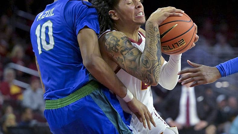 Nov 7, 2022; Los Angeles, California, USA;  USC Trojans guard Tre White (22) is defended by Florida Gulf Coast Eagles forward Zach Anderson (10) as he drives to the basket in the first half at Galen Center. Mandatory Credit: Jayne Kamin-Oncea-USA TODAY Sports