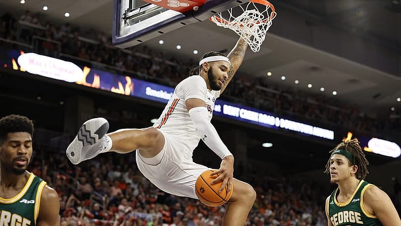 Nov 7, 2022; Auburn, Alabama, USA;  Auburn Tigers forward Johni Broome (4) catches the ball after making a dunk against the George Mason Patriots during the second half at Neville Arena. Mandatory Credit: John Reed-USA TODAY Sports