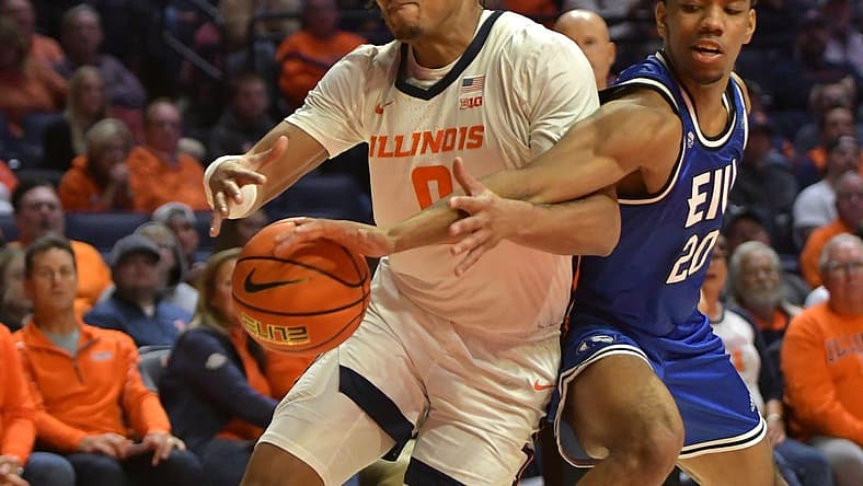 Nov 7, 2022; Champaign, Illinois, USA; Eastern Illinois Panthers guard Caleb Donaldson (20) slaps the ball from Illinois Fighting Illini guard Terrence Shannon Jr. (0) during the first half at State Farm Center. Mandatory Credit: Ron Johnson-USA TODAY Sports
