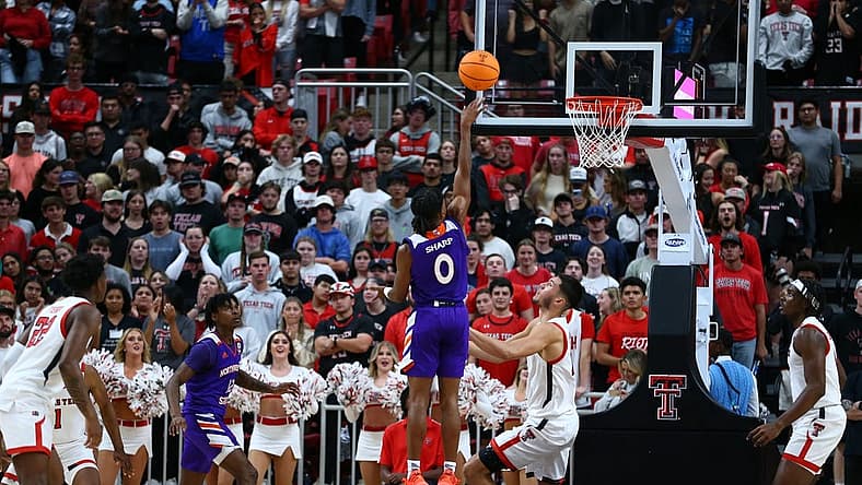 Nov 7, 2022; Lubbock, Texas, USA; Northwestern State Demons guard Demarcus Sharp (0) shoots over Texas Tech Red Raiders forward Daniel Batcho (12) in the second half at United Supermarkets Arena. Mandatory Credit: Michael C. Johnson-USA TODAY Sports