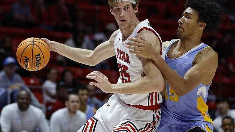 Nov 7, 2022; Salt Lake City, Utah, USA; Utah Utes center Branden Carlson (35) drives against LIU Sharks forward C.J. Delancy (15) in the first half at Jon M. Huntsman Center. Mandatory Credit: Jeffrey Swinger-USA TODAY Sports