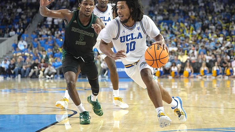 Nov 7, 2022; Los Angeles, California, USA; UCLA Bruins guard Tyger Campbell (10) dribbles the ball against Sacramento State Hornets guard Gianni Hunt (5) in the second half at Pauley Pavilion. Mandatory Credit: Kirby Lee-USA TODAY Sports