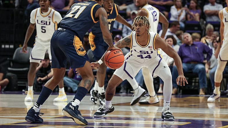 Nov 9, 2022; Baton Rouge, Louisiana, USA; UMKC Kangaroos guard RayQuawndis Mitchell (21) dribbles against LSU Tigers guard Adam Miller (44) during the first half at Pete Maravich Assembly Center. Mandatory Credit: Stephen Lew-USA TODAY Sports