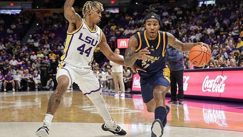 Nov 9, 2022; Baton Rouge, Louisiana, USA; UMKC Kangaroos guard RayQuawndis Mitchell (21) dribbles against LSU Tigers guard Adam Miller (44) during the second half at Pete Maravich Assembly Center. Mandatory Credit: Stephen Lew-USA TODAY Sports