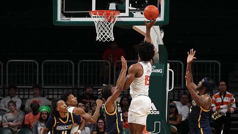 Nov 11, 2022; Coral Gables, Florida, USA; Miami Hurricanes forward Norchad Omier (15) shoots the ball against the UNC Greensboro Spartans during the first half at Watsco Center. Mandatory Credit: Jasen Vinlove-USA TODAY Sports