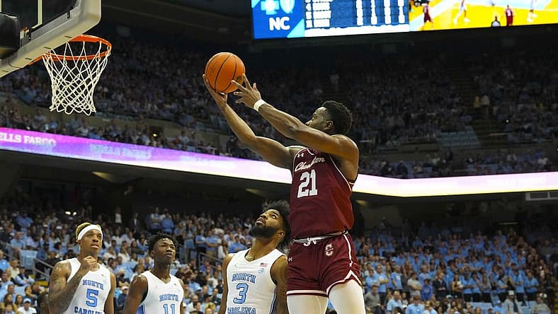 Nov 11, 2022; Chapel Hill, North Carolina, USA; Charleston Cougars guard Jaylon Scott (21) goes to the basket against North Carolina Tar Heels guard Dontrez Styles (3) during the first half at Dean E. Smith Center. Mandatory Credit: James Guillory-USA TODAY Sports