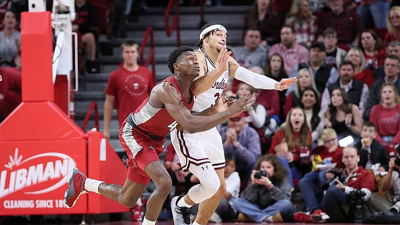 Nov 11, 2022; Fayetteville, Arkansas, USA; Arkansas Razorbacks guard Davonte Davis (4) and Fordham Rams guard Darius Quisenberry (3) reach for a loose ball in the first half at Bud Walton Arena. Mandatory Credit: Nelson Chenault-USA TODAY Sports