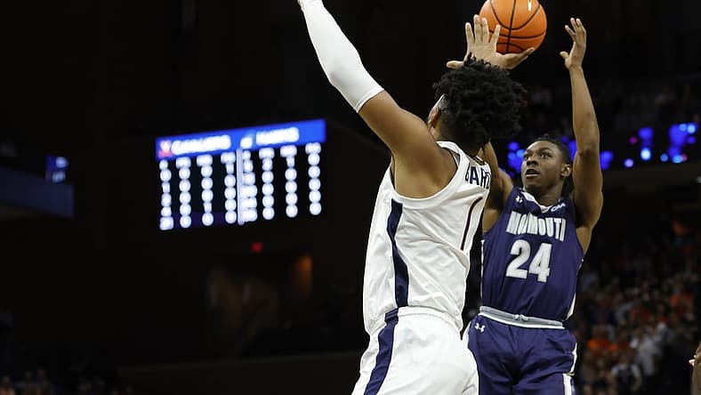 Nov 11, 2022; Charlottesville, Virginia, USA; Monmouth Hawks guard Myles Ruth (24) shoots the ball as Virginia Cavaliers forward Jayden Gardner (1) defends in the first half at John Paul Jones Arena. Mandatory Credit: Geoff Burke-USA TODAY Sports