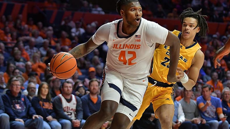 Nov 11, 2022; Champaign, Illinois, USA; Illinois Fighting Illini forward Dain Dainja (42) drives the ball past UMKC Kangaroos guard Tyler Andrews (25) during the first half at State Farm Center. Mandatory Credit: Ron Johnson-USA TODAY Sports
