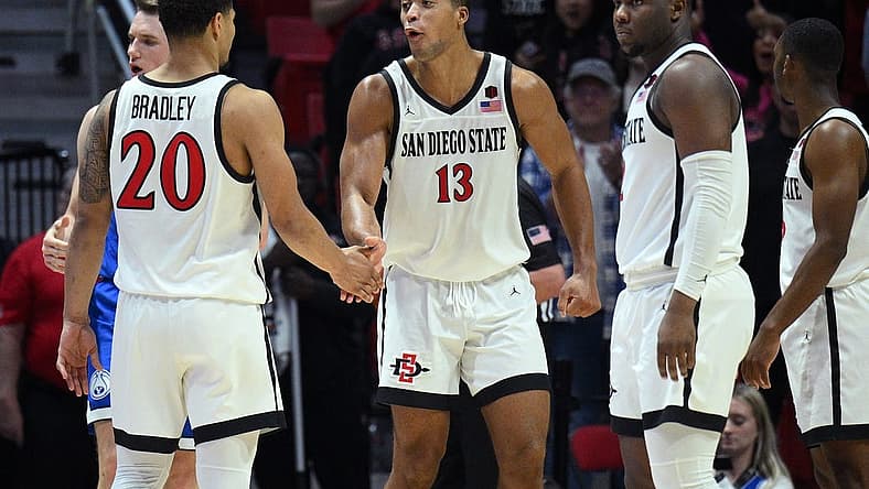 Nov 11, 2022; San Diego, California, USA; San Diego State Aztecs forward Jaedon LeDee (13) celebrates with guard Matt Bradley (20) during the second half against the Brigham Young Cougars at Viejas Arena. Mandatory Credit: Orlando Ramirez-USA TODAY Sports