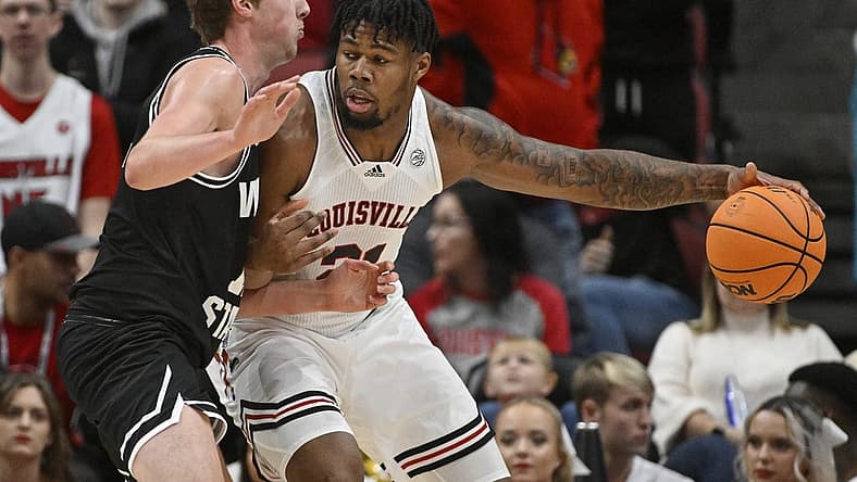 Nov 12, 2022; Louisville, Kentucky, USA;  Louisville Cardinals forward Sydney Curry (21) posts up against Wright State Raiders center AJ Braun (12) during the first half at KFC Yum! Center. Mandatory Credit: Jamie Rhodes-USA TODAY Sports