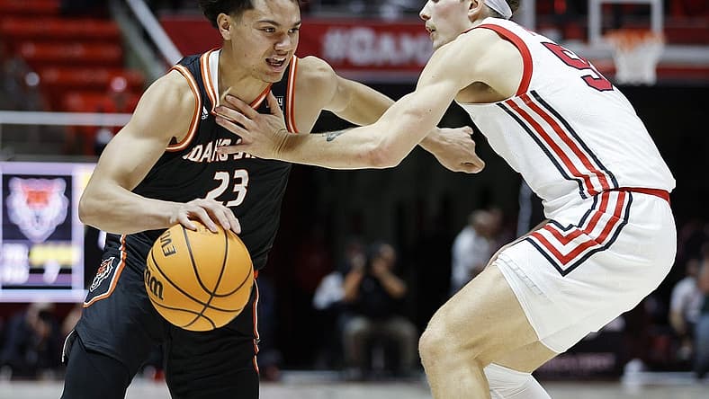 Nov 14, 2022; Salt Lake City, Utah, USA; Idaho State Bengals guard Maleek Arington (23) drives against Utah Utes guard Gabe Madsen (55) in the first half at Jon M. Huntsman Center. Mandatory Credit: Jeffrey Swinger-USA TODAY Sports