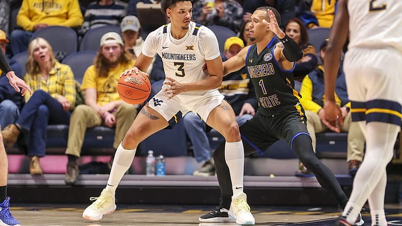 Nov 15, 2022; Morgantown, West Virginia, USA; West Virginia Mountaineers forward Tre Mitchell (3) backs down Morehead State Eagles guard Tucson Redding (1) during the first half at WVU Coliseum. Mandatory Credit: Ben Queen-USA TODAY Sports