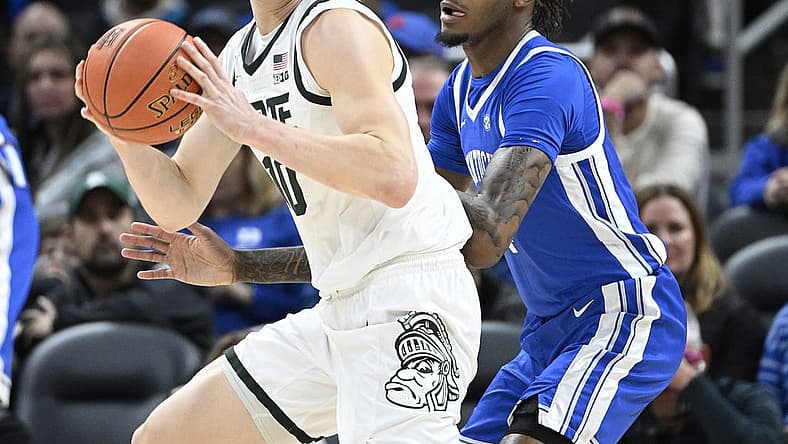 Nov 15, 2022; Indianapolis, Indiana, USA;  Kentucky Wildcats forward Daimion Collins (4) guards Michigan State Spartans forward Joey Hauser (10) during the first half at Gainbridge Fieldhouse. Mandatory Credit: Marc Lebryk-USA TODAY Sports