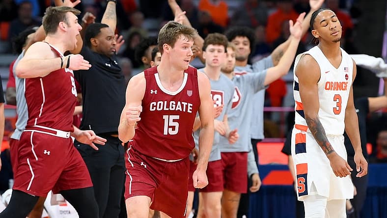 Nov 15, 2022; Syracuse, New York, USA; Colgate Raiders guard Tucker Richardson (15) gestures after his three-point basket as as Syracuse Orange guard Judah Mintz (3) reacts during the second half at the JMA Wireless Dome. Mandatory Credit: Rich Barnes-USA TODAY Sports