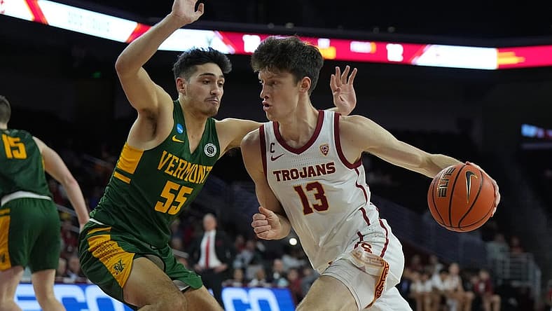 Nov 15, 2022; Los Angeles, California, USA; Southern California Trojans guard Drew Peterson (13) dribbles the ball against Vermont Catamounts guard Robin Duncan (55) in the first half at Galen Center. Mandatory Credit: Kirby Lee-USA TODAY Sports