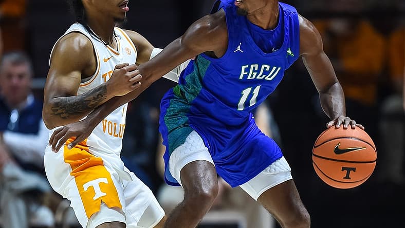 Nov 16, 2022; Knoxville, Tennessee, USA; Florida Gulf Coast Eagles guard Isaiah Thompson (11) controls the ball against Tennessee Volunteers guard Zakai Zeigler (5) during the first half at Thompson-Boling Arena. Mandatory Credit: Bryan Lynn-USA TODAY Sports