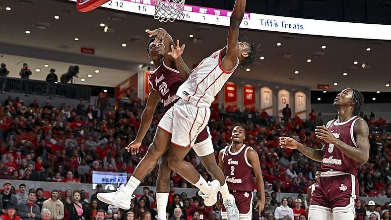 Nov 16, 2022; Houston, Texas, USA; Houston Cougars guard Marcus Sasser (0) shoots over Texas Southern Tigers guard Zytarious Mortle (12) during the first half at Fertitta Center. Mandatory Credit: Maria Lysaker-USA TODAY Sports