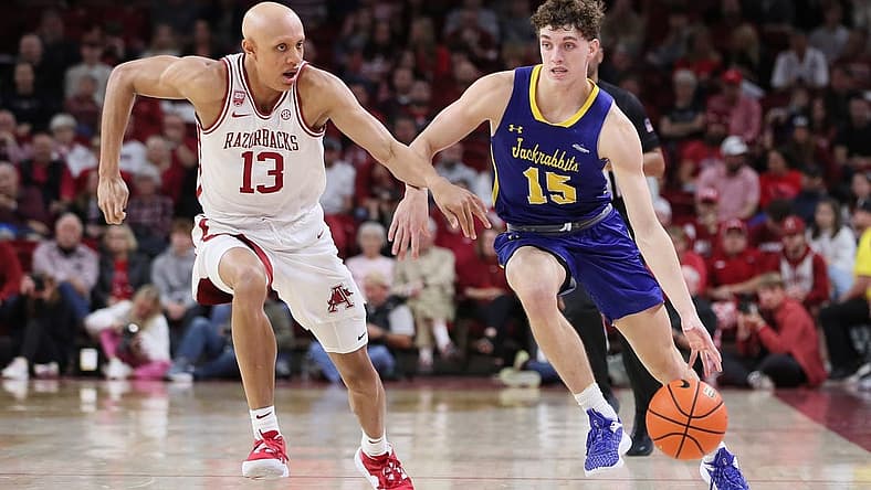 Nov 16, 2022; Fayetteville, Arkansas, USA; South Dakota State Jackrabbits guard Tanner Te Slaa (15) drives against Arkansas Razorbacks guard Jordan Walsh (13) in the first half at Bud Walton Arena. Mandatory Credit: Nelson Chenault-USA TODAY Sports