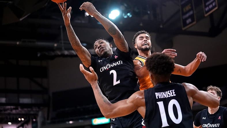 Cincinnati Bearcats guard Landers Nolley II (2) competes for a rebound against Northern Kentucky Norse guard Trey Robinson (1) in the second half during a college basketball game, Wednesday, Nov. 16, 2022, at Truist Arena in Highland Heights, Ky. The Northern Kentucky Norse won, 64-51.

Cincinnati Bearcats At Northern Kentucky Norse Nov 16 0057