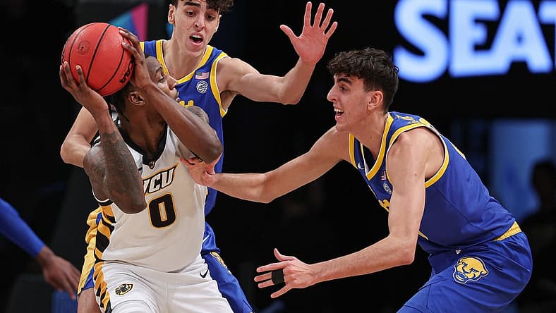 Nov 17, 2022; Brooklyn, New York, USA; Virginia Commonwealth Rams forward Jamir Watkins (0) shields the ball as Pittsburgh Panthers forward Jorge Diaz Graham (31) and forward Guillermo Diaz Graham (25) defend during the first half at Barclays Center. Mandatory Credit: Vincent Carchietta-USA TODAY Sports