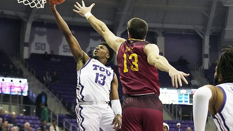 Nov 17, 2022; Fort Worth, Texas, USA; TCU Horned Frogs guard Shahada Wells (13) drives to the basket on Louisiana Monroe Warhawks forward Thomas Howell (13) during the first half at Ed and Rae Schollmaier Arena. Mandatory Credit: Raymond Carlin III-USA TODAY Sports