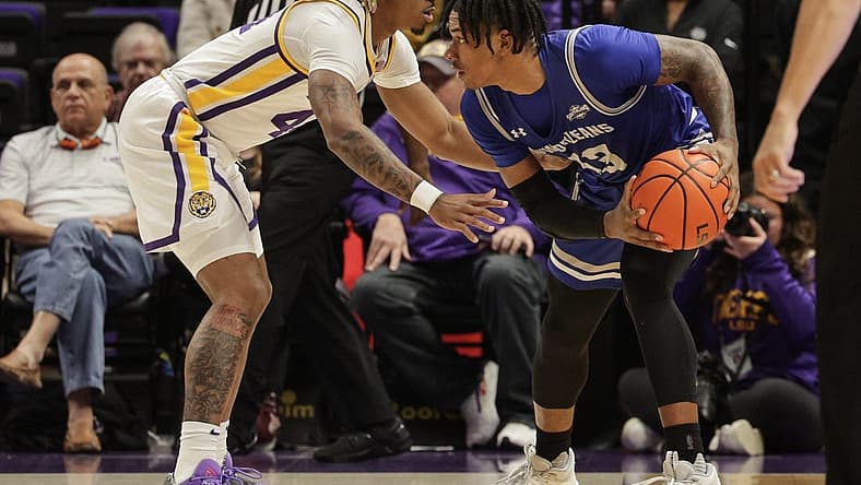 Nov 17, 2022; Baton Rouge, Louisiana, USA; New Orleans Privateers guard Jamond Vincent (13) looks to pass the ball against LSU Tigers guard Adam Miller (44) during the first half at Pete Maravich Assembly Center. Mandatory Credit: Stephen Lew-USA TODAY Sports