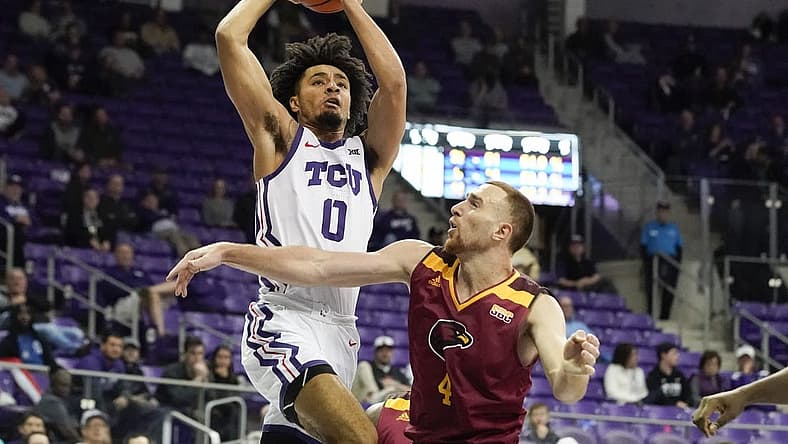 Nov 17, 2022; Fort Worth, Texas, USA; TCU Horned Frogs guard Micah Peavy (0) drives to the basket on Louisiana Monroe Warhawks forward Nika Metskhvarishvili (4) during the second half at Ed and Rae Schollmaier Arena. Mandatory Credit: Raymond Carlin III-USA TODAY Sports