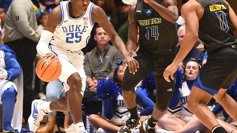 Nov 18, 2022; Durham, North Carolina, USA; Duke Blue Devils forward Mark Mitchell (25) dribbles the ball as Delaware Blue Hens guard Ebby Asamoah (14) defends during the first half at Cameron Indoor Stadium. Mandatory Credit: Rob Kinnan-USA TODAY Sports
