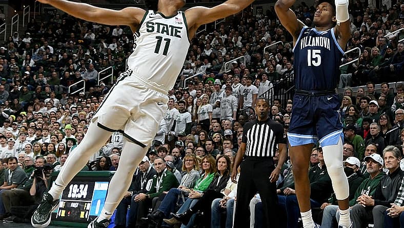 Nov 18, 2022; East Lansing, Michigan, USA;  Villanova Wildcats guard Jordan Longino (15) shoots past Michigan State Spartans guard A.J. Hoggard (11) at Jack Breslin Student Events Center. Mandatory Credit: Dale Young-USA TODAY Sports