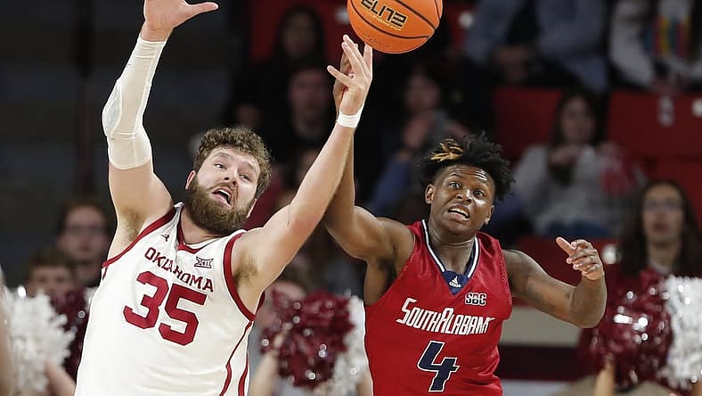 Nov 18, 2022; Norman, Oklahoma, USA; Oklahoma Sooners forward Tanner Groves (35) and South Alabama Jaguars guard Isaiah Moore (4) reach for a loose ball during the first half at Lloyd Noble Center. Mandatory Credit: Alonzo Adams-USA TODAY Sports
