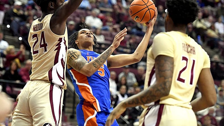 Nov 18, 2022; Tallahassee, Florida, USA; Florida Gators guard Will Richard (5) goes up for a shot past Florida State Seminoles center Naheem McLeod (24) during the first half at Donald L. Tucker Center. Mandatory Credit: Melina Myers-USA TODAY Sports