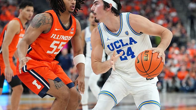 Nov 18, 2022; Las Vegas, Nevada, USA; UCLA Bruins guard Jaime Jaquez Jr. (24) dribbles against Illinois Fighting Illini guard Skyy Clark (55) during the second half at T-Mobile Arena. Mandatory Credit: Stephen R. Sylvanie-USA TODAY Sports