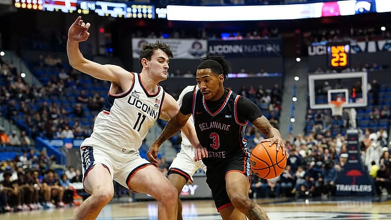 Nov 20, 2022; Hartford, Connecticut, USA; Delaware State Hornets guard Martaz Robinson (3) dribbles the ball against Connecticut Huskies forward Alex Karaban (11) during the first half at XL Center. Mandatory Credit: Gregory Fisher-USA TODAY Sports