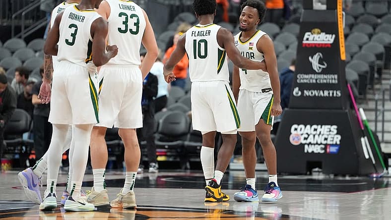 Nov 20, 2022; Las Vegas, Nevada, USA; Baylor Bears guard LJ Cryer (4) celebrates with Baylor Bears guard Adam Flagler (10) after the Bears defeated the UCLA Bruins 80-75 at T-Mobile Arena. Mandatory Credit: Stephen R. Sylvanie-USA TODAY Sports