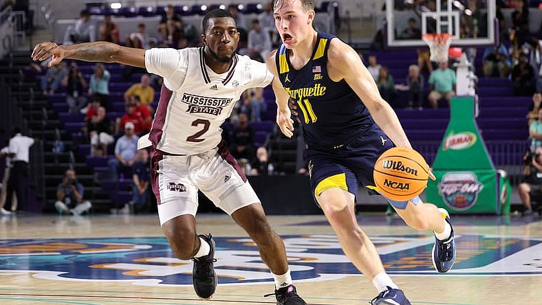 Nov 21, 2022; Fort Myers, Florida, USA; Marquette Golden Eagles guard Tyler Kolek (11) drives to the basket past Mississippi State Bulldogs guard Jamel Horton Jr. (2) in the first half during the Fort Myers Tip-off at Suncoast Credit Union Arena. Mandatory Credit: Nathan Ray Seebeck-USA TODAY Sports
